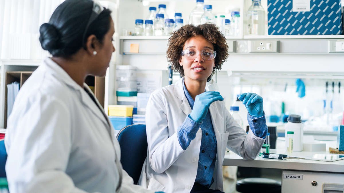 Two female scientists talking in a lab