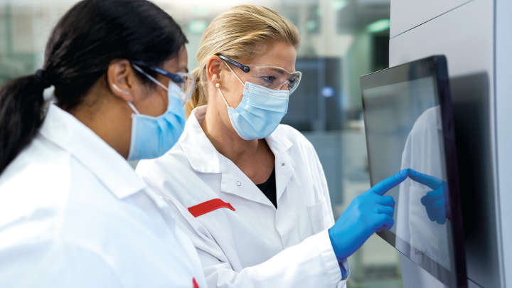 QIAstat Rise, syndromic testing, female scientists working on instrument screen