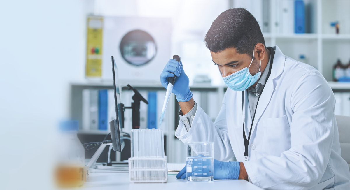 Enzymes, NGS, Black male pipetting in front of computer screen in a laboratory environment