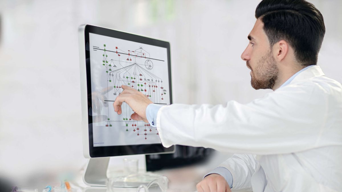 Male scientist in front of a computer