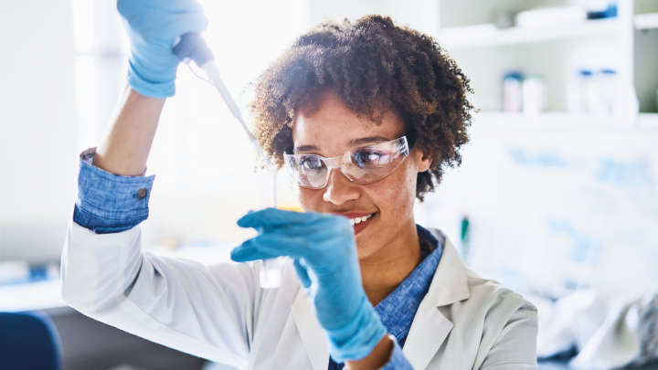 Woman in lab smiling