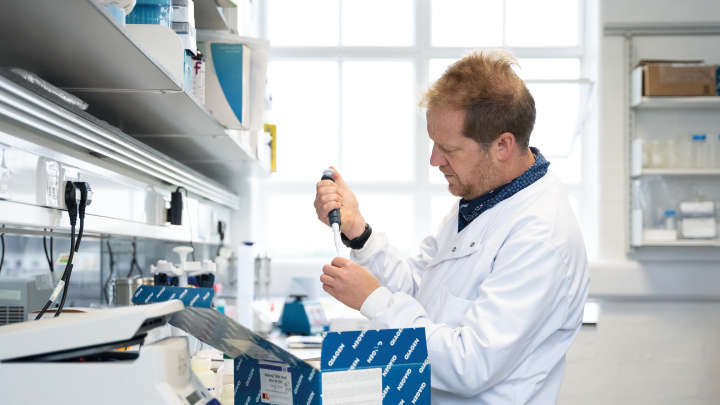 Man in labcoat sampling 