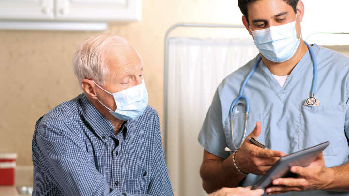 male doctor in conversation with older male patient