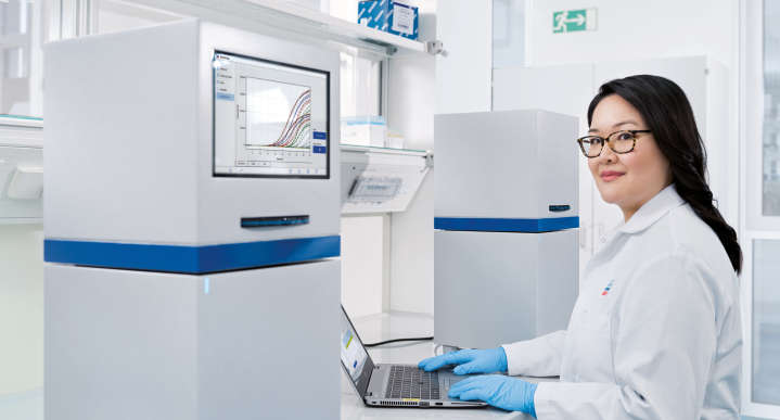 woman in lab with laptop checking lab results
