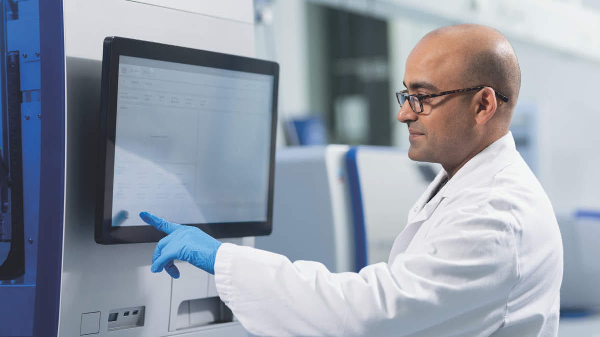 Lab director checking display on instrument